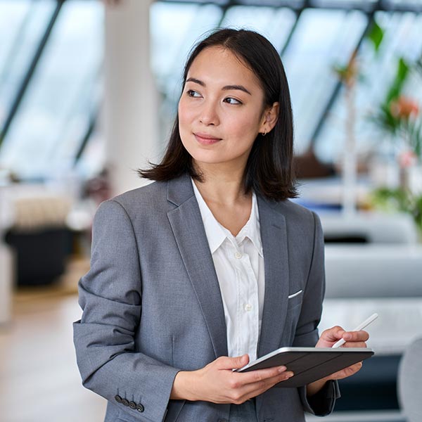 stock-photo-young-asian-business-woman-entrepreneur-standing-in-office-holding-digital-tablet-businesswoman-2184502325 businesswoman in an interior