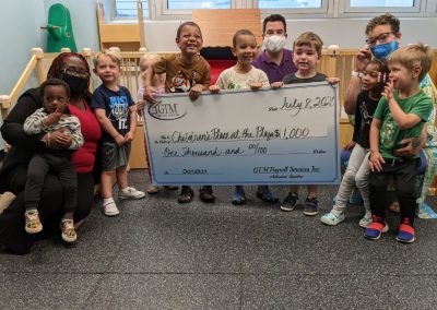 Children's Place at the Plaza holding a large check