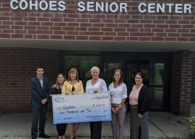 Cohoes Senior Center holding a large check