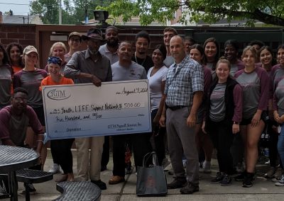 Youth L.I.F.E Support holding a large check